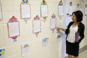 Karyn Chiapella, paraprofessional at Scranton Public School and certified trainer of Step Up to Writing, points out some of the Scranton students' work posted in the hallways that use the new writing program. (Pioneer Photo by Bryce Martin)