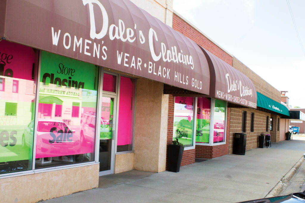 The front windows of Dale’s Clothing & Custom Embroidery on Main Street in Bowman are covered in brightly colored paper, catching the eye of passersby for the large liquidation sale. (Pioneer Photo by Bryce Martin)