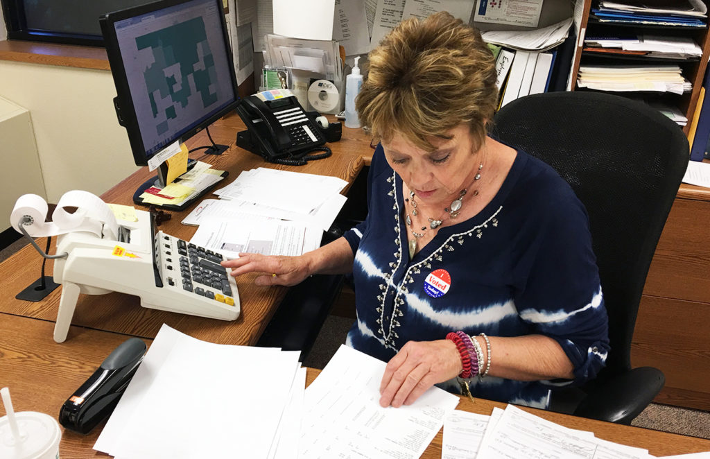Bowman County Auditor Sandi Tivis reviews the results from the primary election June 14. (Pioneer Photo by Bryce Martin)
