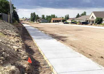 Sidewalks are added along the east side of Eleventh Avenue Northwest in Bowman, with the street paving to be finished later this month. (Photo by Sarah Snavely)